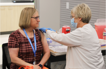 NICO receiving a vaccine through company health fair