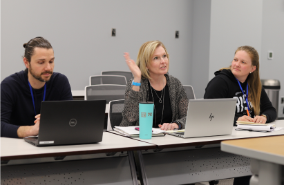 NICO employee raises hand during meeting discussion.