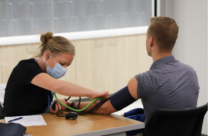 NICO employee receiving blood pressure check at health fair